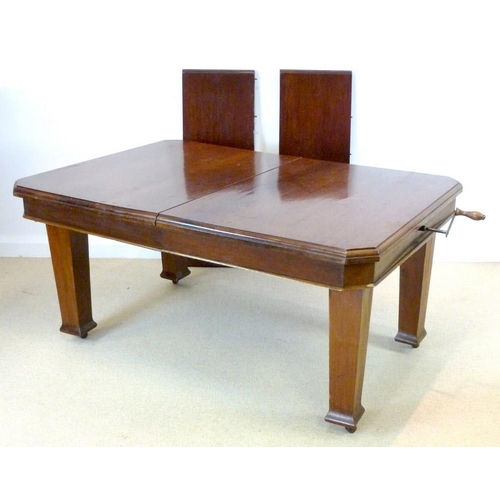 854A - An Edwardian mahogany extending dining table, the surface with canted corners and moulded edge, rais... 