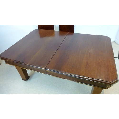 854A - An Edwardian mahogany extending dining table, the surface with canted corners and moulded edge, rais... 