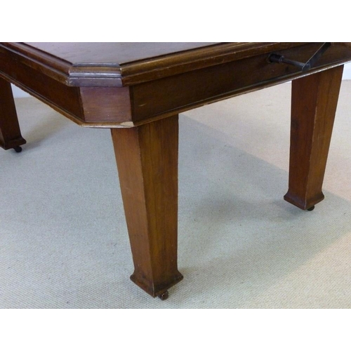 854A - An Edwardian mahogany extending dining table, the surface with canted corners and moulded edge, rais... 