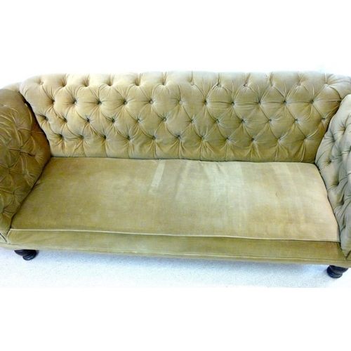 889A - A Victorian mahogany three seater Chesterfield settee, with scroll over arms and turned front legs, ... 