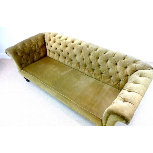 889A - A Victorian mahogany three seater Chesterfield settee, with scroll over arms and turned front legs, ... 