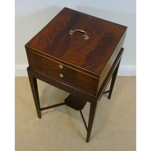 892 - A Georgian deed box on stand, flame mahogany, strung with boxwood, 44 by 44 by 75cm high.