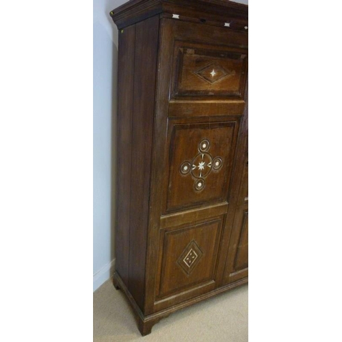 897 - A French 18th century oak cupboard, cornice over two full length doors with carved geometric decorat... 