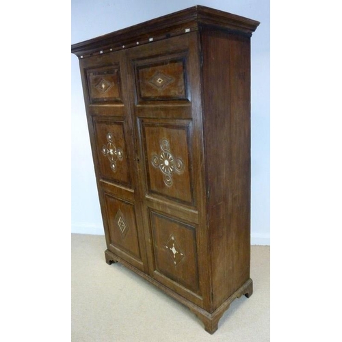 897 - A French 18th century oak cupboard, cornice over two full length doors with carved geometric decorat... 