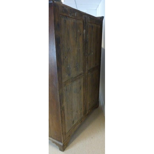 897 - A French 18th century oak cupboard, cornice over two full length doors with carved geometric decorat... 