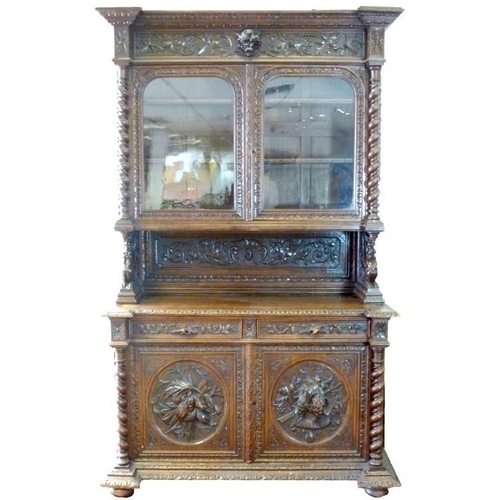 898 - A 19th century oak bookcase, in the 17th century Dutch style, deeply carved cornice over floral frie... 