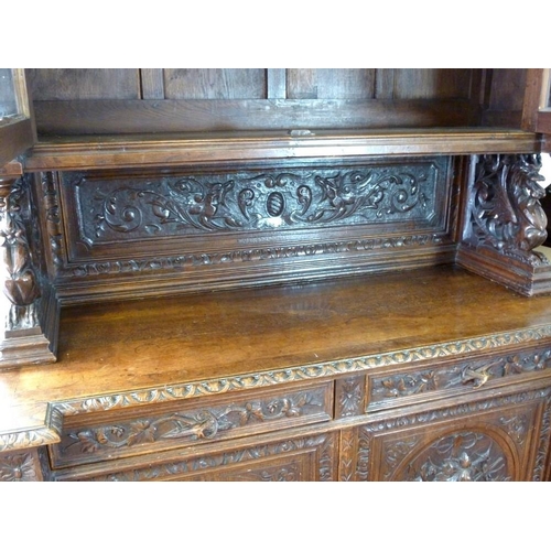 898 - A 19th century oak bookcase, in the 17th century Dutch style, deeply carved cornice over floral frie... 