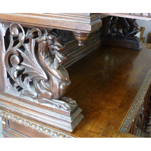 898 - A 19th century oak bookcase, in the 17th century Dutch style, deeply carved cornice over floral frie... 