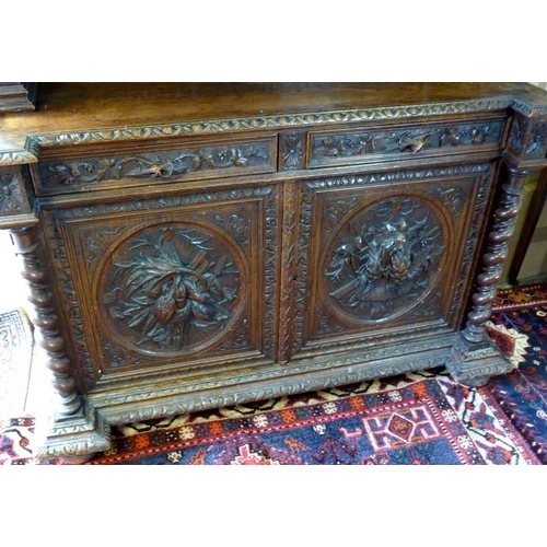 898 - A 19th century oak bookcase, in the 17th century Dutch style, deeply carved cornice over floral frie... 