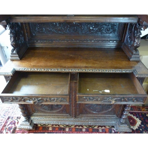 898 - A 19th century oak bookcase, in the 17th century Dutch style, deeply carved cornice over floral frie... 