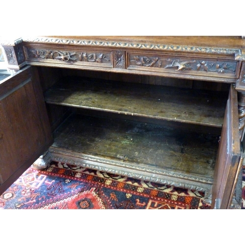 898 - A 19th century oak bookcase, in the 17th century Dutch style, deeply carved cornice over floral frie... 