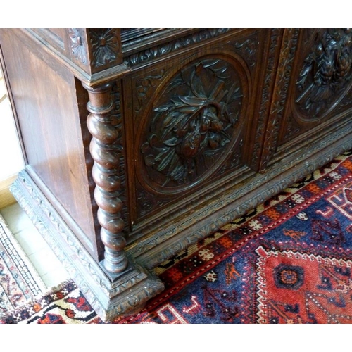 898 - A 19th century oak bookcase, in the 17th century Dutch style, deeply carved cornice over floral frie... 