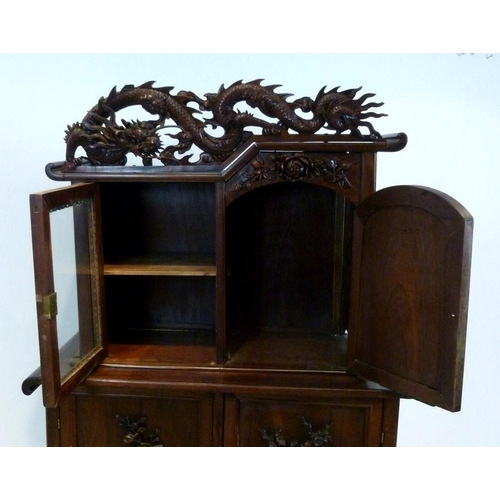 900 - A Japanese hardwood Tansu cupboard display cabinet on stand carved high relief dragon crest, a singl... 