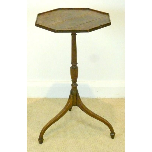 1024 - A George III provincial oak tripod table, circa 1790, the octagonal plank top with a low gallery, on... 