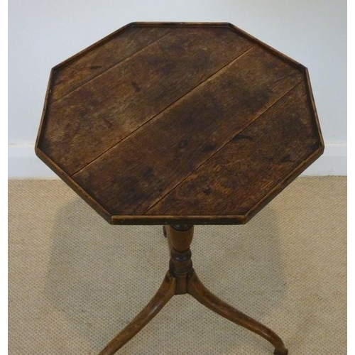 1024 - A George III provincial oak tripod table, circa 1790, the octagonal plank top with a low gallery, on... 