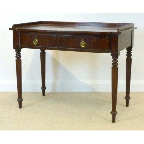 1027 - An early Victorian mahogany dressing table, circa 1840, the three quarter galleried bow fronted top ... 