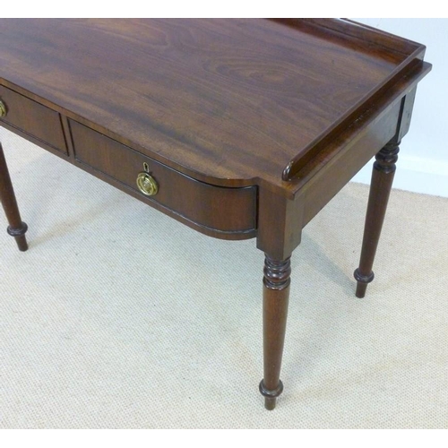 1027 - An early Victorian mahogany dressing table, circa 1840, the three quarter galleried bow fronted top ... 