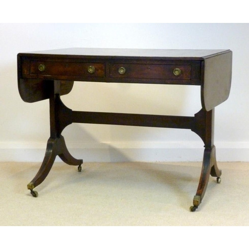 1034 - A Regency mahogany and crossbanded sofa table, two drawers with brass ring handles opposite two fals... 