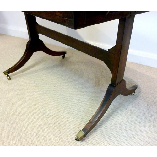 1034 - A Regency mahogany and crossbanded sofa table, two drawers with brass ring handles opposite two fals... 