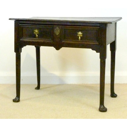 1036 - A George I oak lowboy, circa 1720, the rectangular surface with moulded edge over a single frieze dr... 