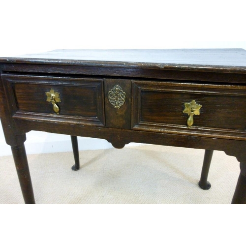 1036 - A George I oak lowboy, circa 1720, the rectangular surface with moulded edge over a single frieze dr... 