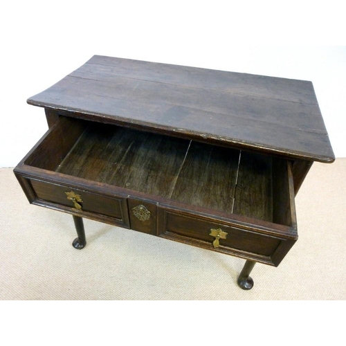 1036 - A George I oak lowboy, circa 1720, the rectangular surface with moulded edge over a single frieze dr... 