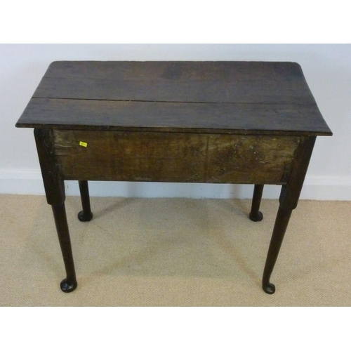 1036 - A George I oak lowboy, circa 1720, the rectangular surface with moulded edge over a single frieze dr... 