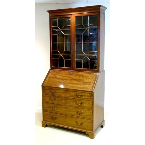 1039 - A George III style mahogany bureau bookcase, circa 1880, the cavetto cornice above a pair of geometr... 