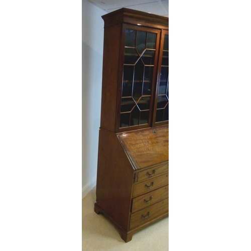 1039 - A George III style mahogany bureau bookcase, circa 1880, the cavetto cornice above a pair of geometr... 