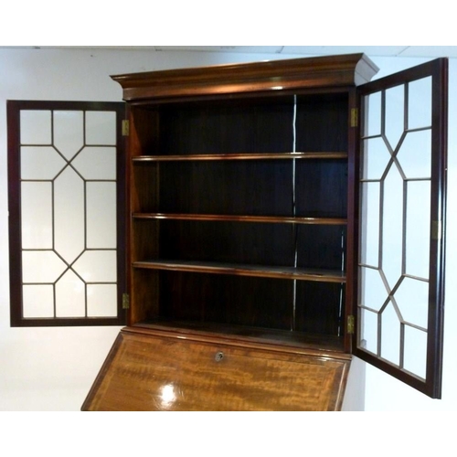 1039 - A George III style mahogany bureau bookcase, circa 1880, the cavetto cornice above a pair of geometr... 