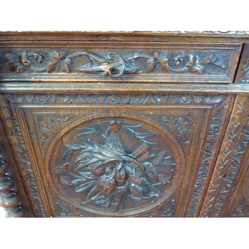 1041 - A 19th century oak bookcase, in the 17th century Dutch style, deeply carved cornice over floral frie... 