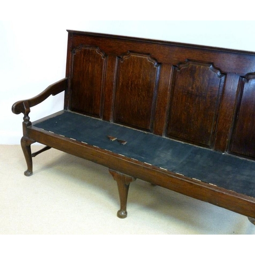 1043 - A mid 18th century provincial oak settle, the rectangular back with four arched fielded panels conti... 