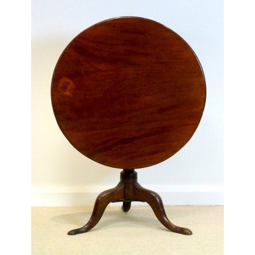 1044 - A George IV mahogany tripod table, circa 1825, the circular tilt top raised on a vase and ring-turne... 