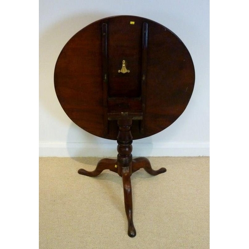 1044 - A George IV mahogany tripod table, circa 1825, the circular tilt top raised on a vase and ring-turne... 