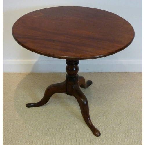 1044 - A George IV mahogany tripod table, circa 1825, the circular tilt top raised on a vase and ring-turne... 