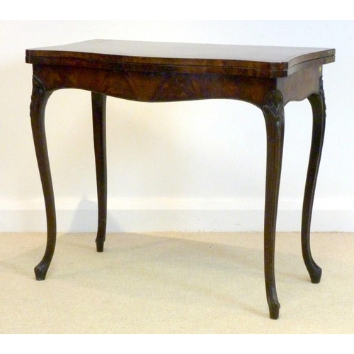 1045 - A George III mahogany and kingwood banded card table, circa 1785, in the French taste, the hinged se... 