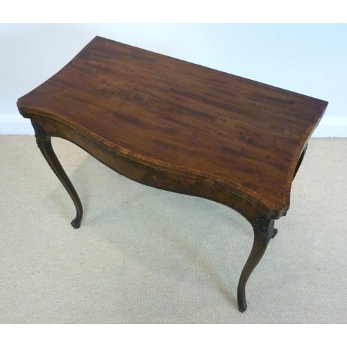 1045 - A George III mahogany and kingwood banded card table, circa 1785, in the French taste, the hinged se... 