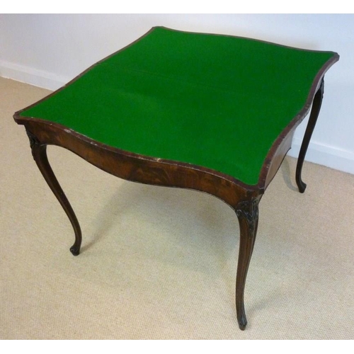 1045 - A George III mahogany and kingwood banded card table, circa 1785, in the French taste, the hinged se... 