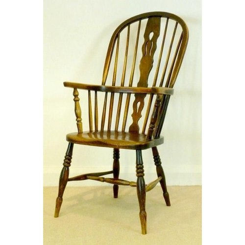 1049 - A 19th century Windsor armchair with solid elm saddle seat, pierced splat, raised on turned legs and... 