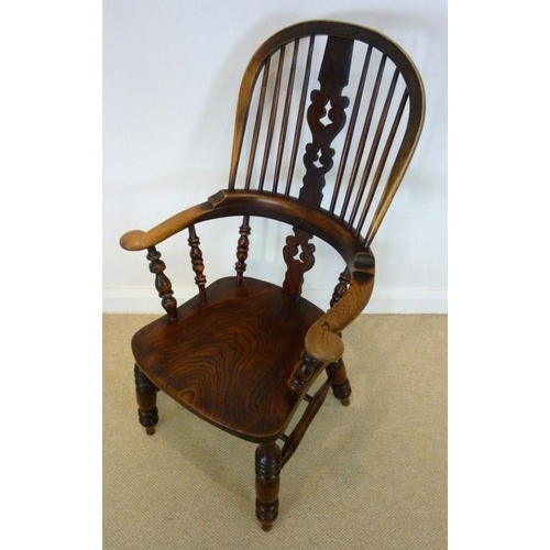 1052 - A late 18th century Windsor armchair with outswept broad arms, a stepped back rail, and pierced and ... 