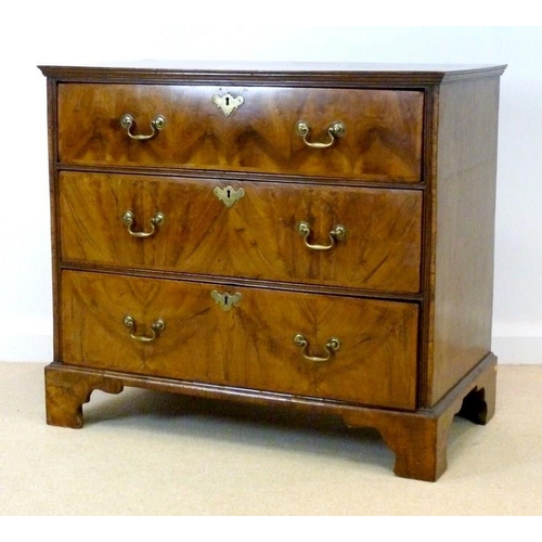 1053 - A George I walnut chest, the crossbanded rectangular top with a moulded edge over three long crossba... 