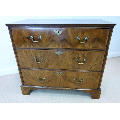 1053 - A George I walnut chest, the crossbanded rectangular top with a moulded edge over three long crossba... 