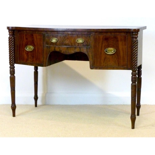 1055 - A Regency mahogany bowfront sideboard, circa 1820, the top with outset rounded corners over one shal... 