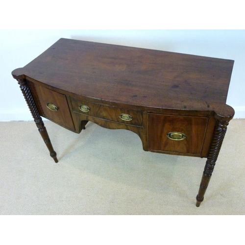 1055 - A Regency mahogany bowfront sideboard, circa 1820, the top with outset rounded corners over one shal... 