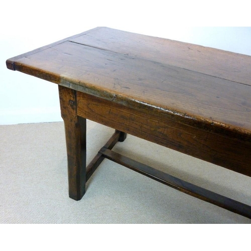 1056 - An early 18th century oak refectory table, the cleated twin plank top above a drawer to one end on s... 