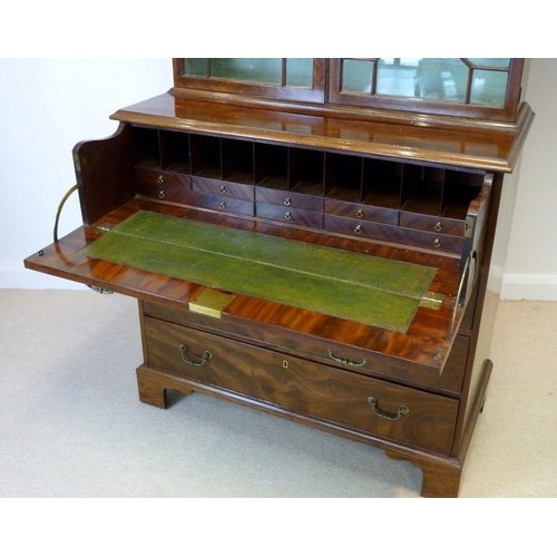 1058 - A George III mahogany secretaire cabinet, circa 1775, the acanthus carved fretwork swan-neck pedimen... 