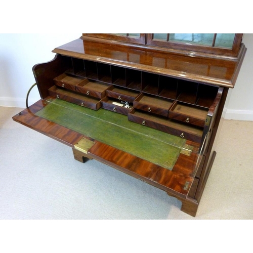 1058 - A George III mahogany secretaire cabinet, circa 1775, the acanthus carved fretwork swan-neck pedimen... 