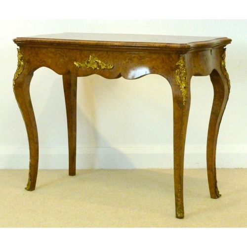 1059 - A Victorian burr walnut card table, circa 1870, the mirror veneered serpentine top with a moulded ed... 