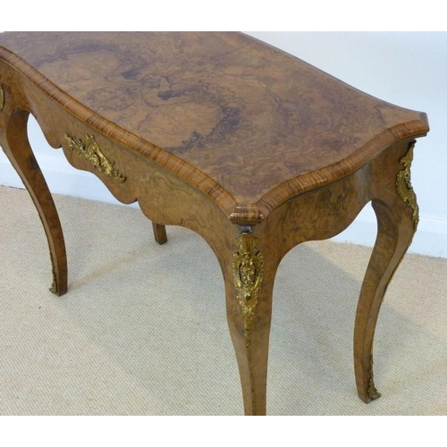 1059 - A Victorian burr walnut card table, circa 1870, the mirror veneered serpentine top with a moulded ed... 