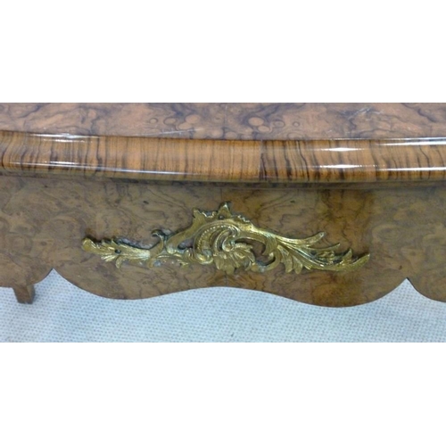 1059 - A Victorian burr walnut card table, circa 1870, the mirror veneered serpentine top with a moulded ed... 